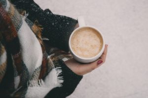 Hands around a hot drink in winter