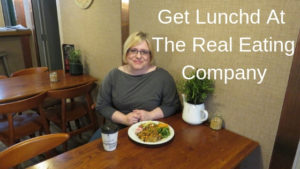 woman sat at table in the real eating company for lunch