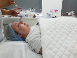 chemical peel being added to lady's face