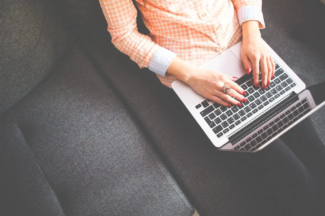 lady sat with laptop freelance blogging