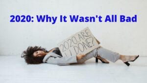 woman lying on floor holding a sign that says 2020 are u done