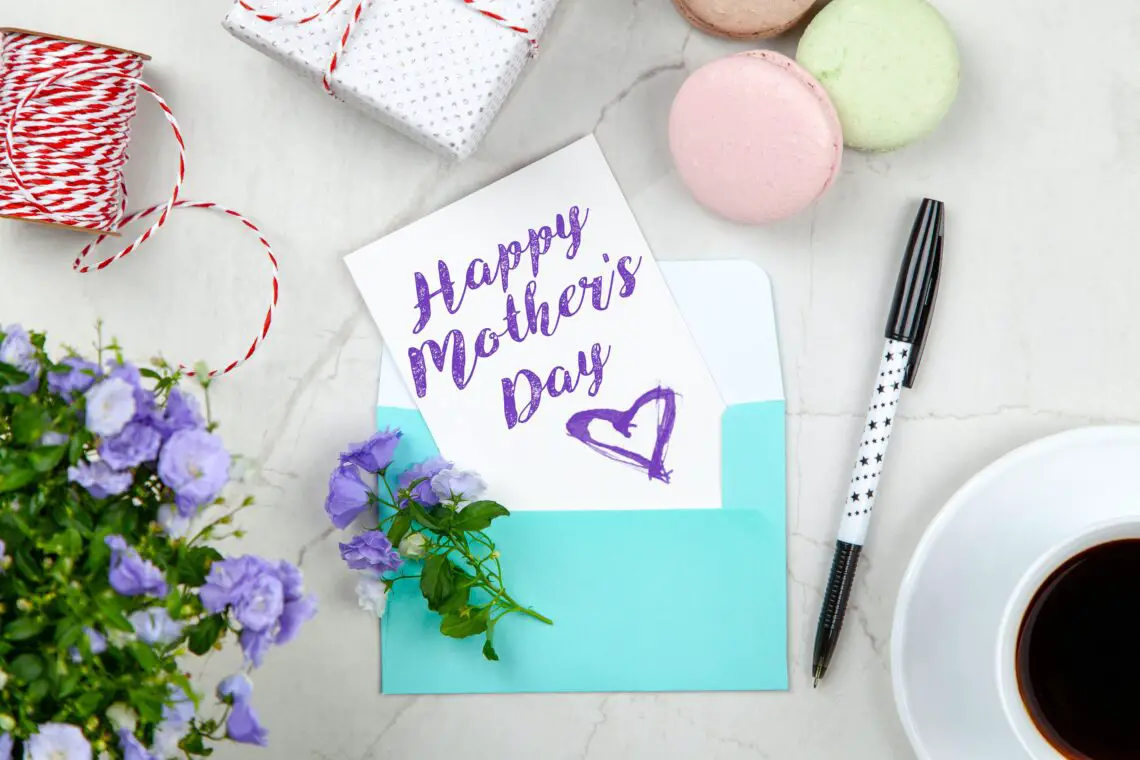 Stationery, flowers, cookies, a gift and a card for Mother's day on a table