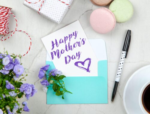 Stationery, flowers, cookies, a gift and a card for Mother's day on a table