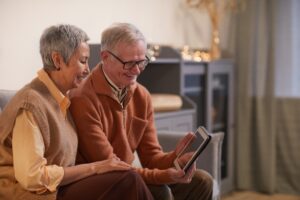 Older couple looking at a photo about their best lifephoto