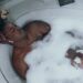 person relaxing in a bubble bath for self-care
