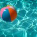 beach ball on swimming pool in summer