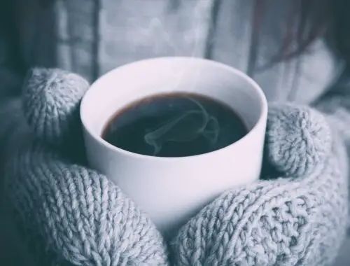 Winter mittens and cup of coffee