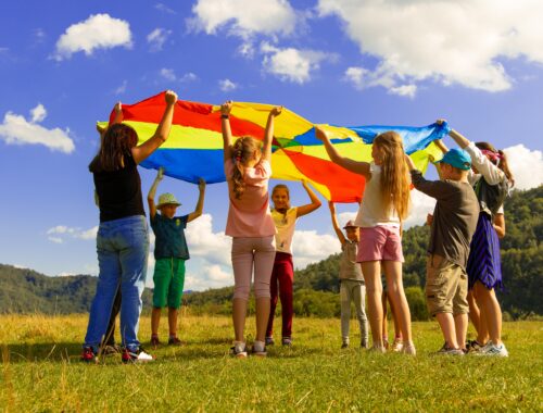 kids with a parachute outside in Spring
