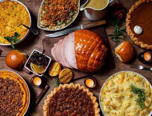 a table full of Autumn comfort food, such as pies and pork
