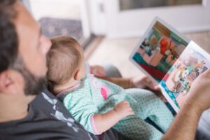 person with a baby on their lap reading a book - blog post ideas for November