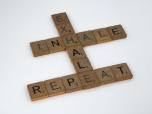 tiles spelling out inhale, exhale and repeat