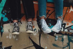 feet of people sat on a ledge: support your teenager's mental health