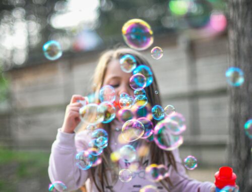 young child with bubbles: family-friendly events to check out in Summer 2024